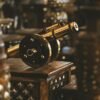 Antique metal cannon showcased in an elegant indoor setting highlighting craftsmanship and traditional decor.