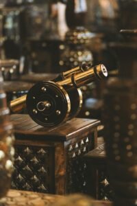 Antique metal cannon showcased in an elegant indoor setting highlighting craftsmanship and traditional decor.