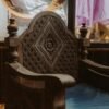 Beautifully carved wooden armchair showcasing vintage design indoors.